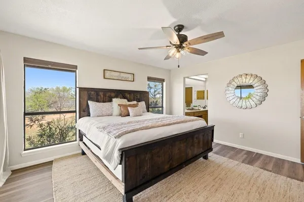 a bedroom with a large bed and a chandelier