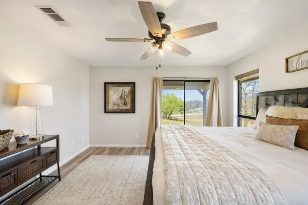 a bedroom with a bed and a lamp on table