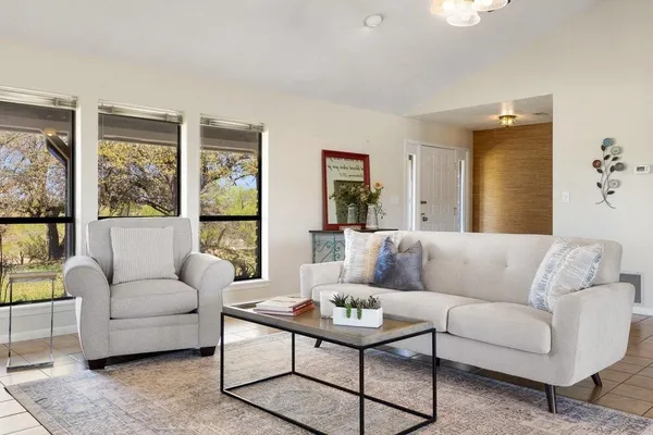 a living room with furniture and a large window