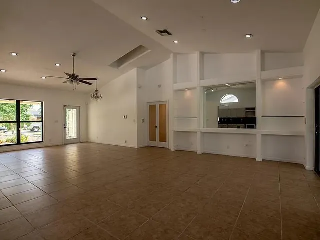 a view of an empty room with a kitchen