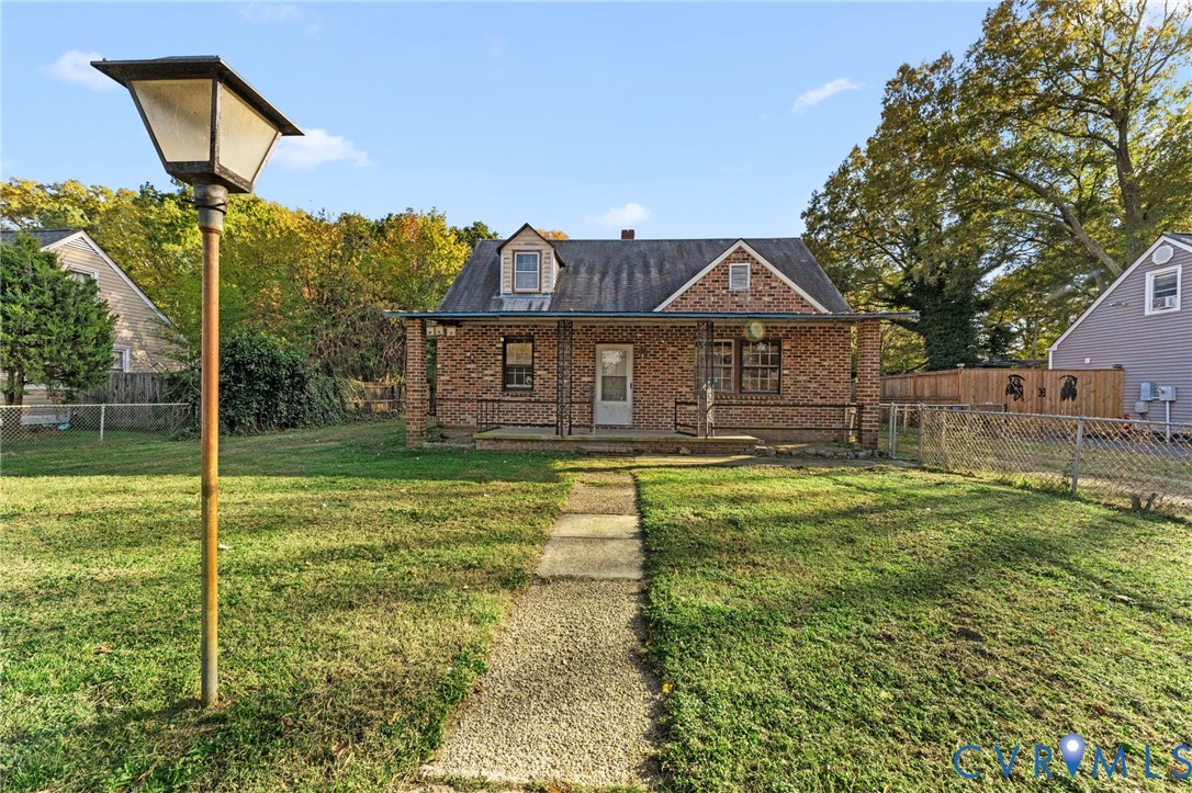 2925 West Strathmore Road Richmond, VA 23237 - Photo 1 of 25 a front view of a house with a yard table and chairs
