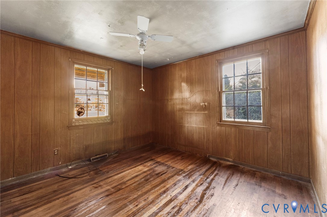 2925 West Strathmore Road Richmond, VA 23237 - Photo 12 of 25 a view of an empty room with a window and wooden floor