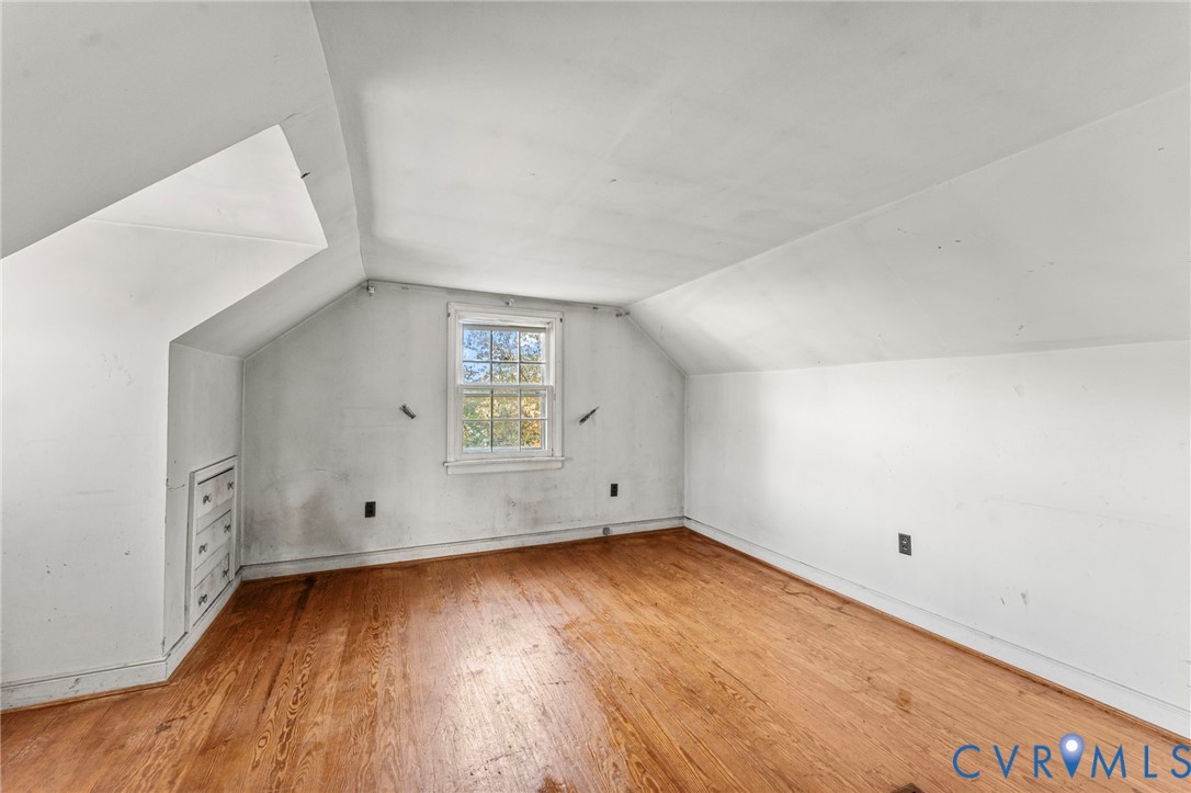 2925 West Strathmore Road Richmond, VA 23237 - Photo 18 of 25 an empty room with wooden floor and windows