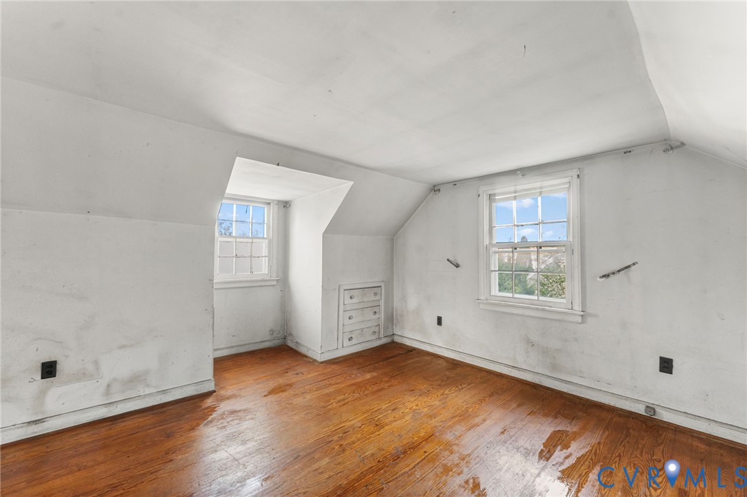 2925 West Strathmore Road Richmond, VA 23237 - Photo 19 of 25 an empty room with wooden floor and windows