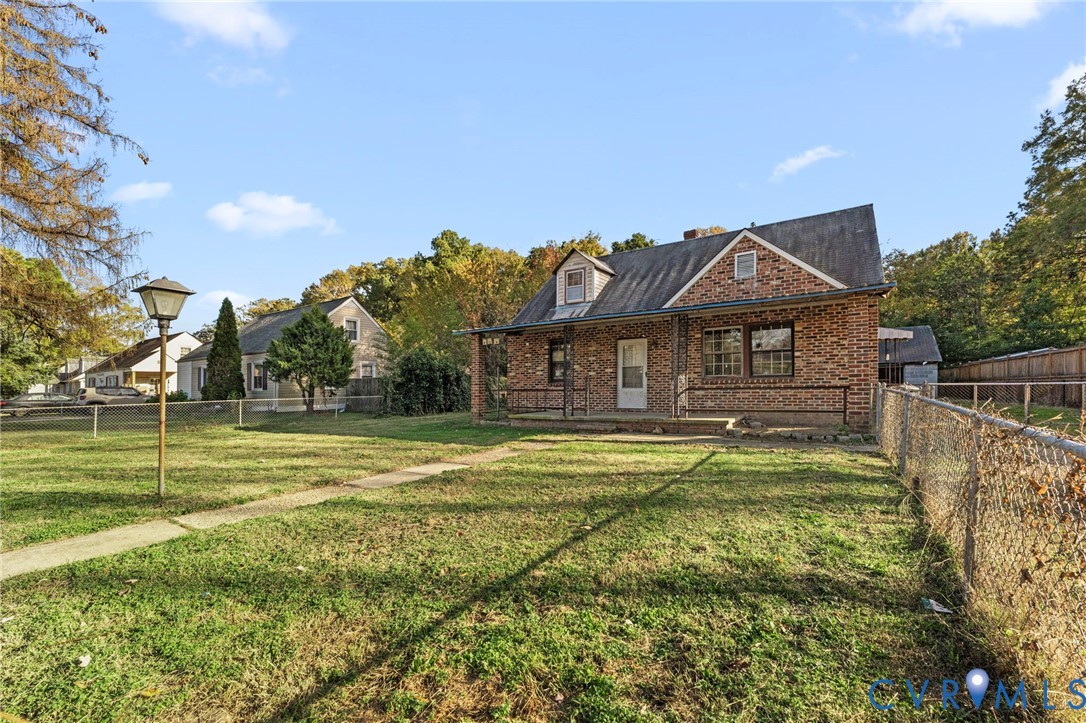 2925 West Strathmore Road Richmond, VA 23237 - Photo 2 of 25 a front view of a house with a yard table and chairs