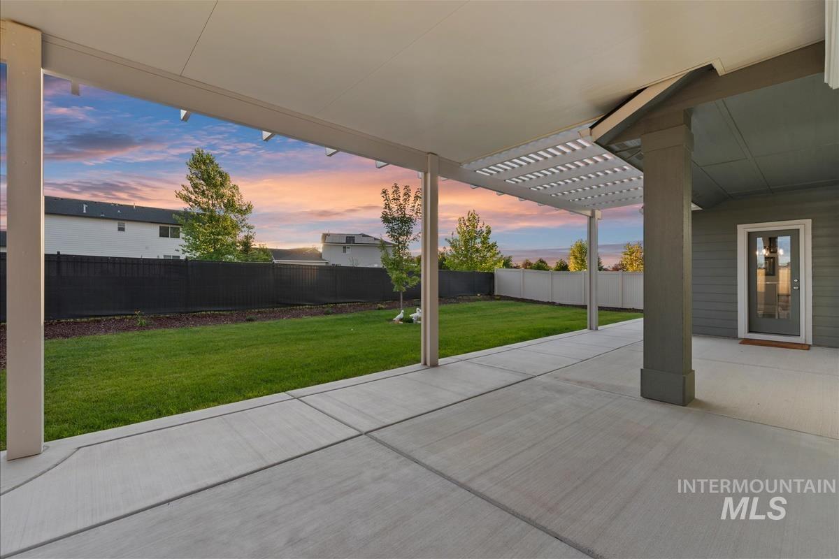 15451 Lutsen Avenue Caldwell, ID 83607 - Photo 35 of 39 Expansive concrete patio featuring a partial pergola and covered area