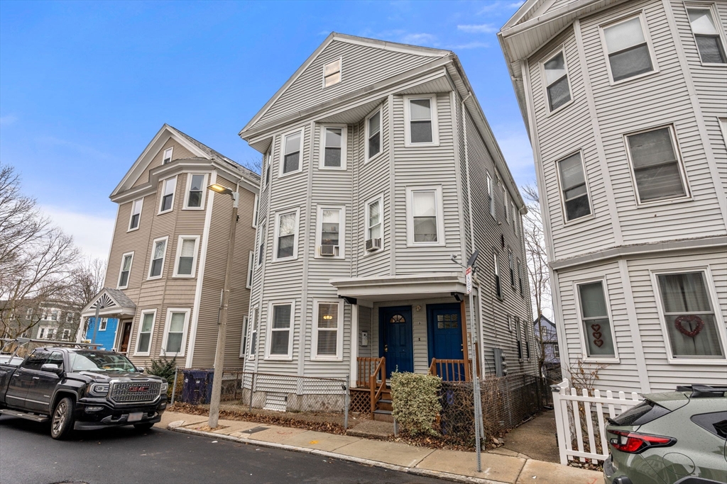 a front view of a residential apartment building with a yard