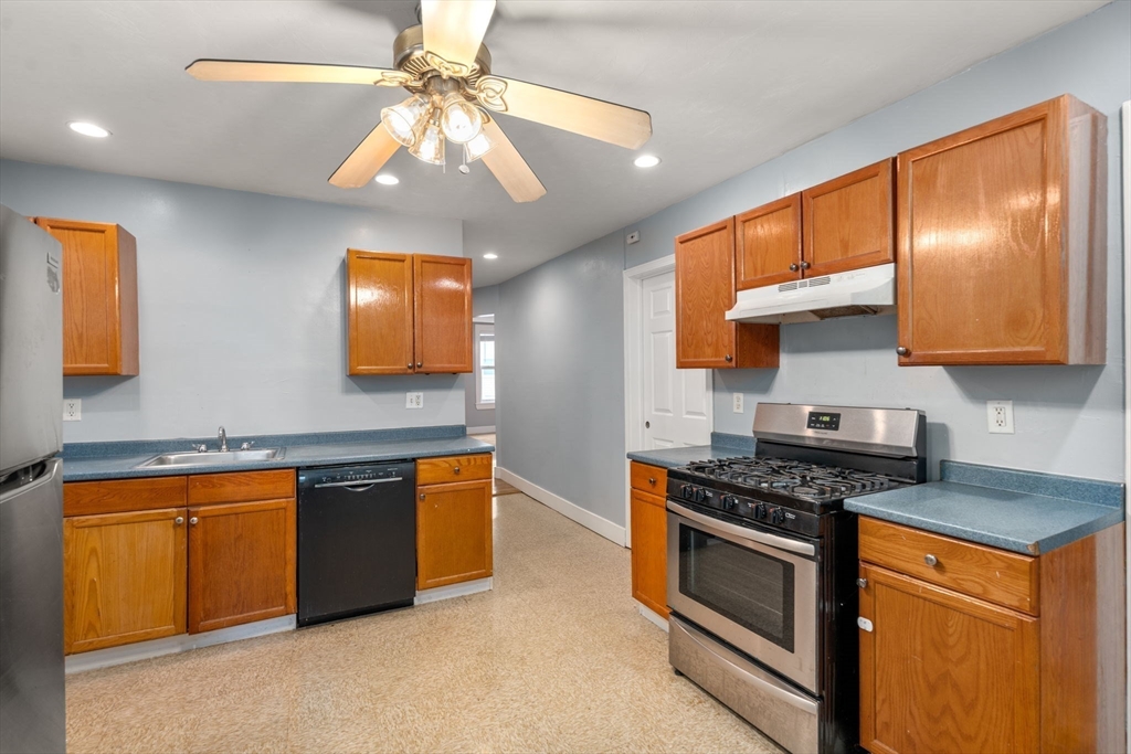 8 Haverford Street Boston, MA 02130 - Photo 6 of 34 a kitchen with stainless steel appliances granite countertop a stove a sink and a microwave