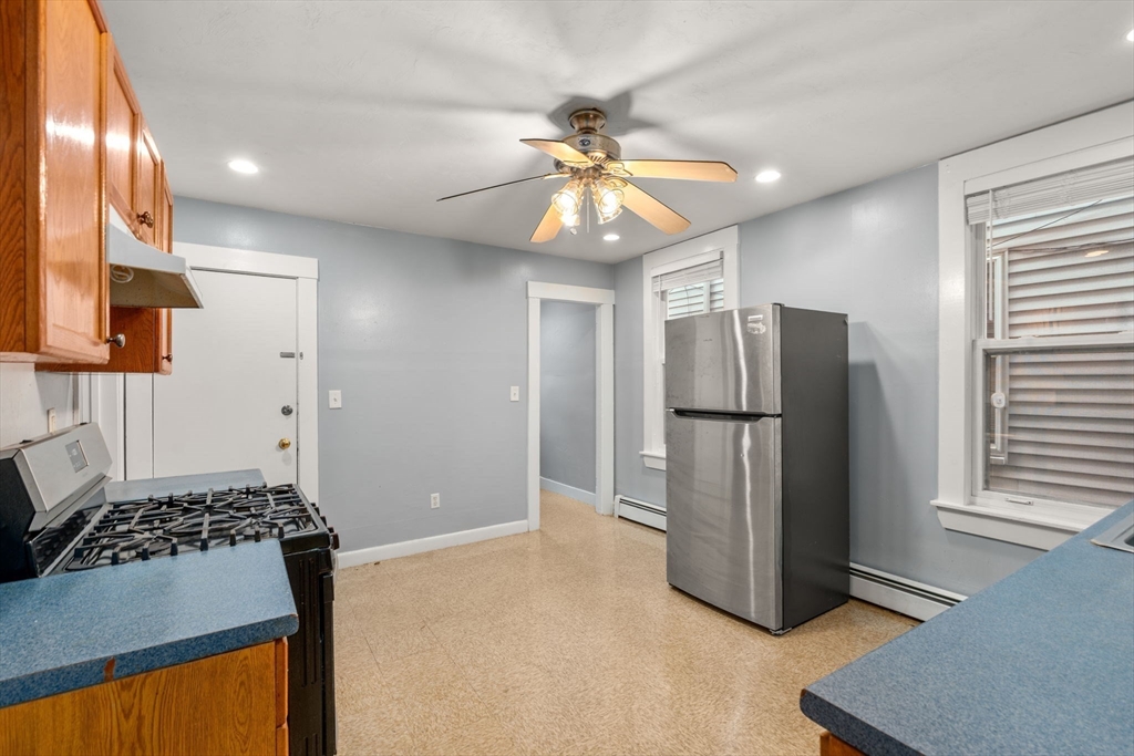8 Haverford Street Boston, MA 02130 - Photo 7 of 34 a kitchen with stainless steel appliances granite countertop a refrigerator and a stove top oven