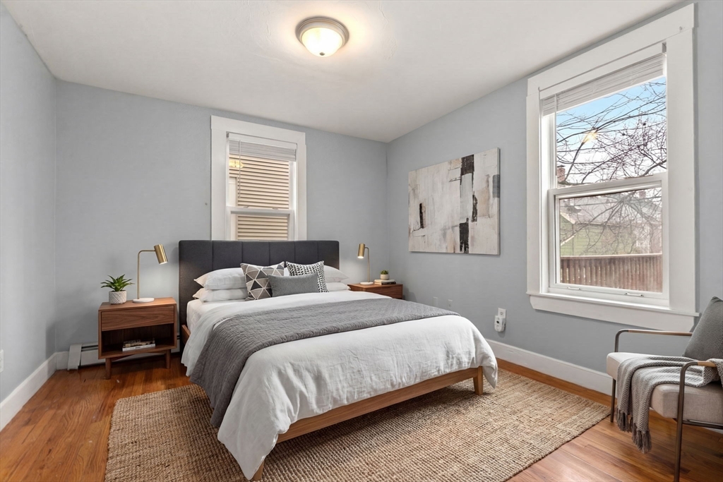 8 Haverford Street Boston, MA 02130 - Photo 9 of 34 a bedroom with a bed wooden floor and windows