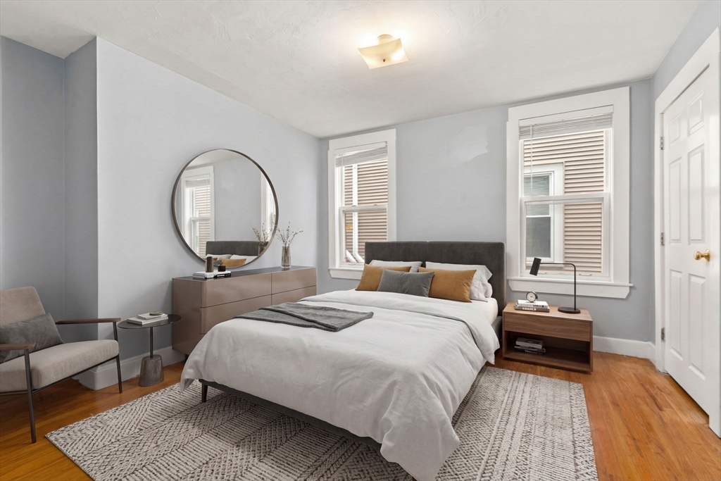8 Haverford Street Boston, MA 02130 - Photo 10 of 34 a spacious bedroom with a bed a mirror and a window