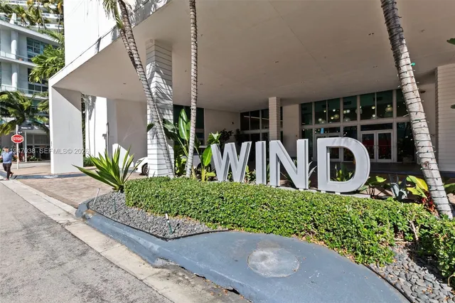 a view of a house with potted plants