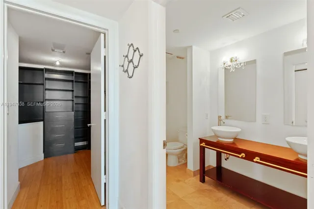 a view of walk in closet with empty racks