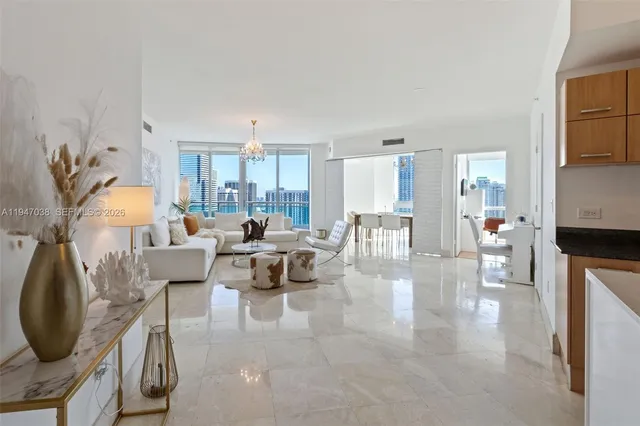 a living room with furniture and a chandelier