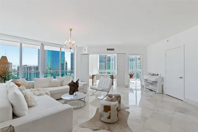 a living room with furniture and a chandelier