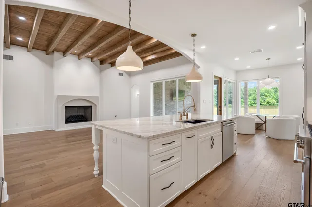 a kitchen with a sink and a stove top oven