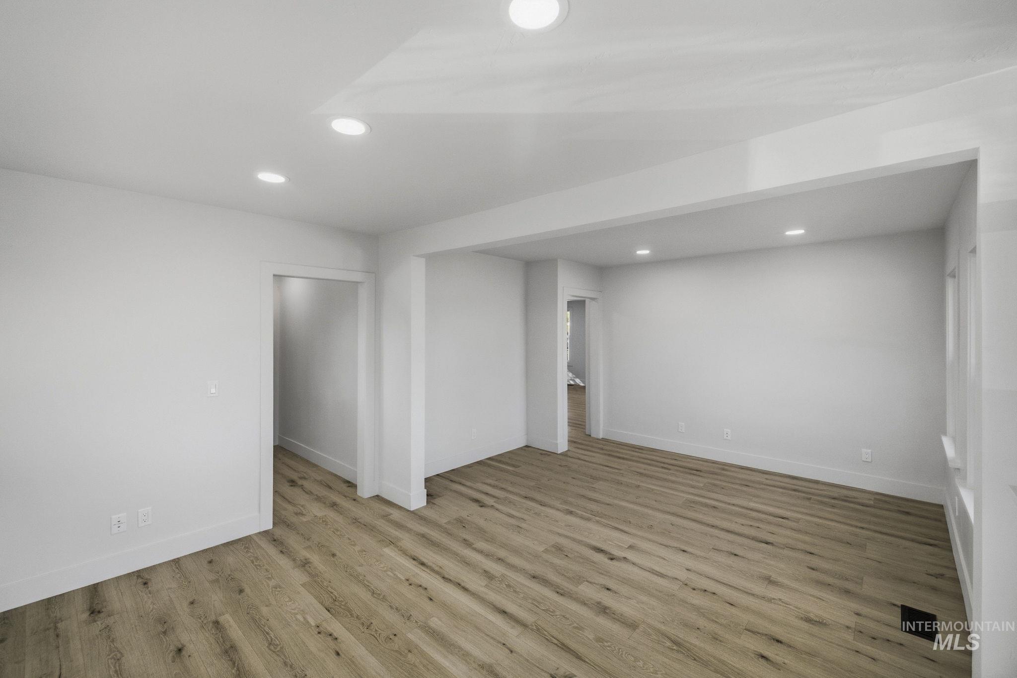 3113 West Overland Road Boise, ID 83705 - Photo 29 of 40 Recessed lighting illuminates the open-concept space featuring light-toned wood-finish flooring and white walls