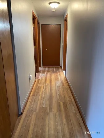 a view of a room with wooden floor and chair