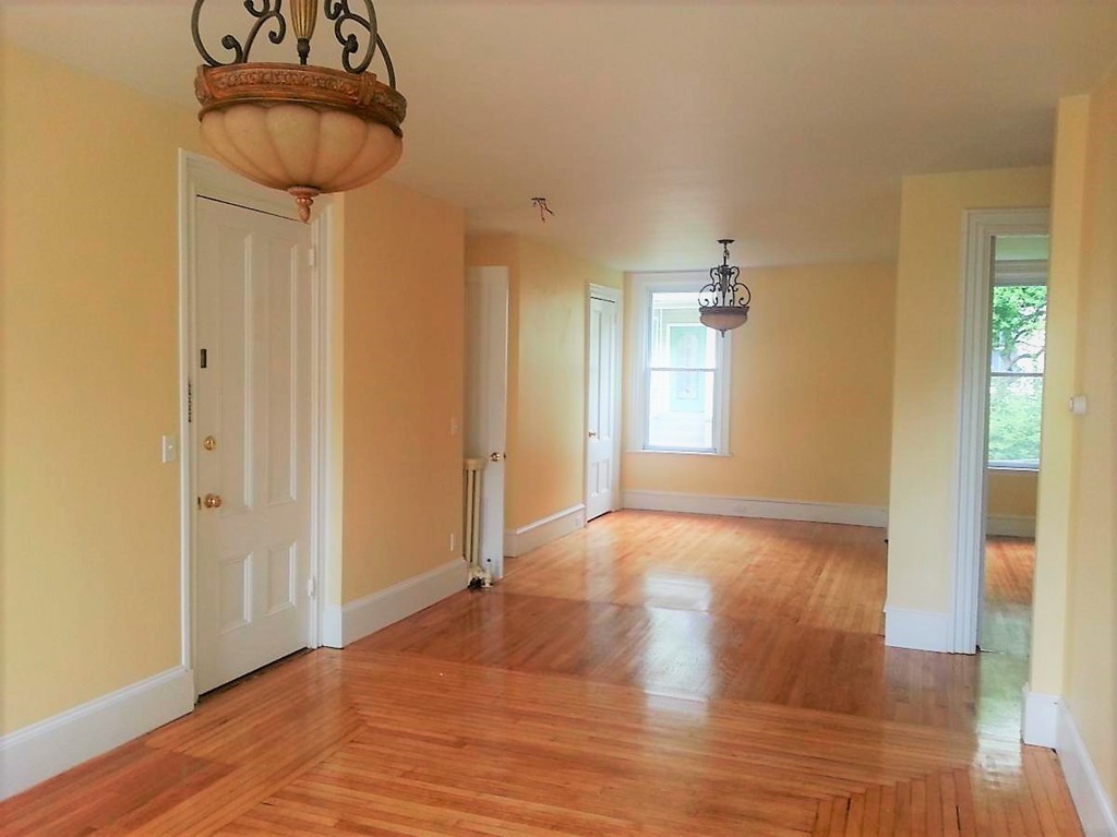 298 Whipple Street Fall River, MA 02721 - Photo 4 of 21 a view of empty room with wooden floor and fan