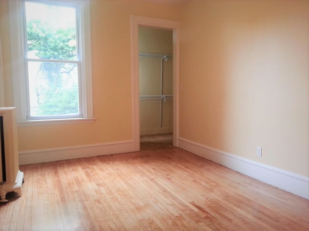298 Whipple Street Fall River, MA 02721 - Photo 6 of 21 an empty room with wooden floor and windows