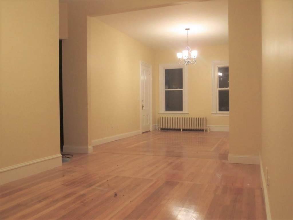 298 Whipple Street Fall River, MA 02721 - Photo 8 of 21 an empty room with wooden floor and bathroom