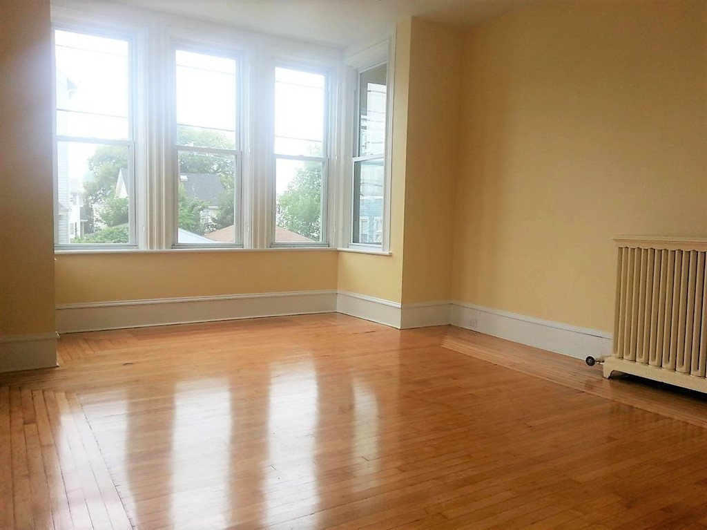 298 Whipple Street Fall River, MA 02721 - Photo 9 of 21 a view of an empty room with wooden floor and a window