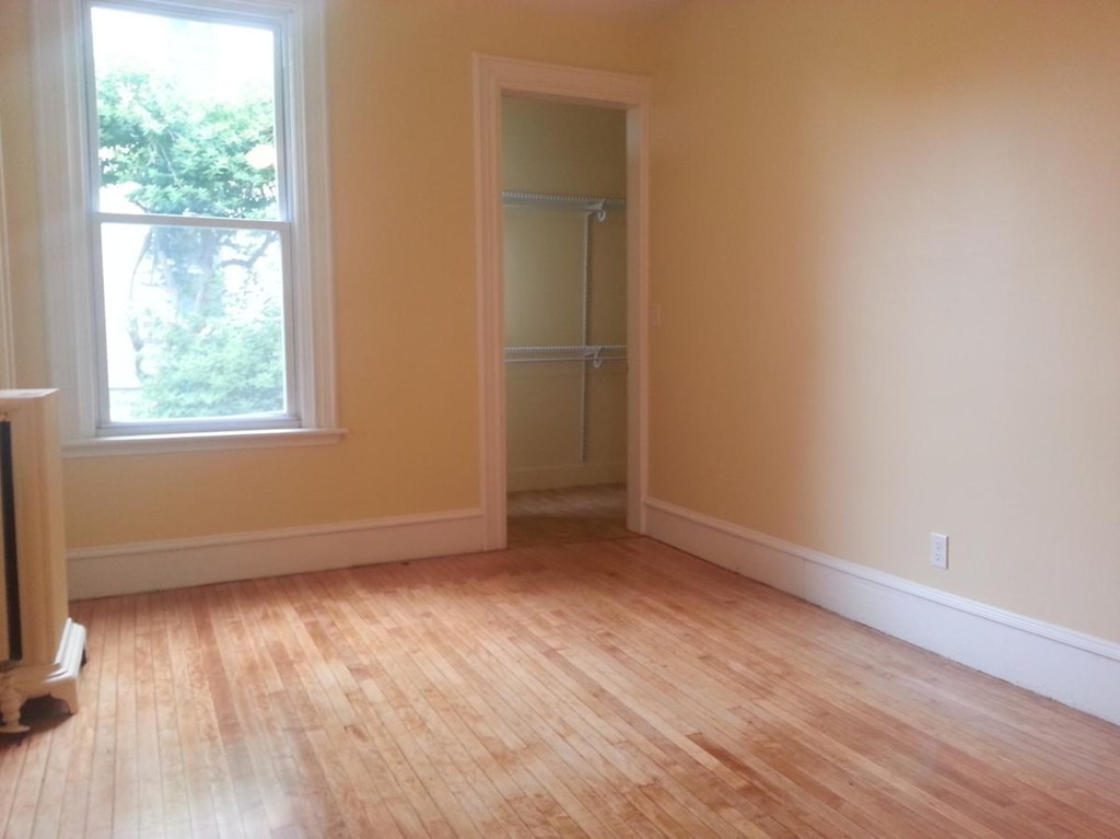 298 Whipple Street Fall River, MA 02721 - Photo 10 of 21 an empty room with wooden floor and windows