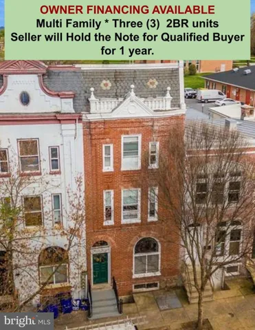 a front view of a building with parking area