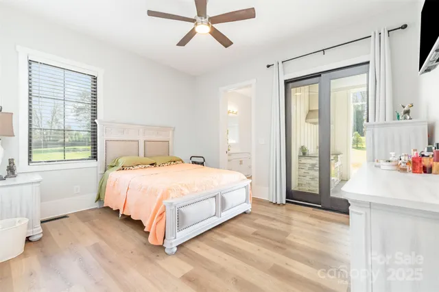 a spacious bedroom with a bed and a large window