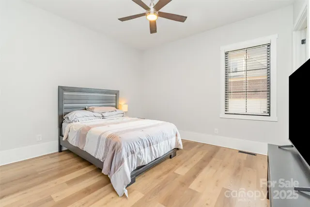 a bedroom with a bed and window