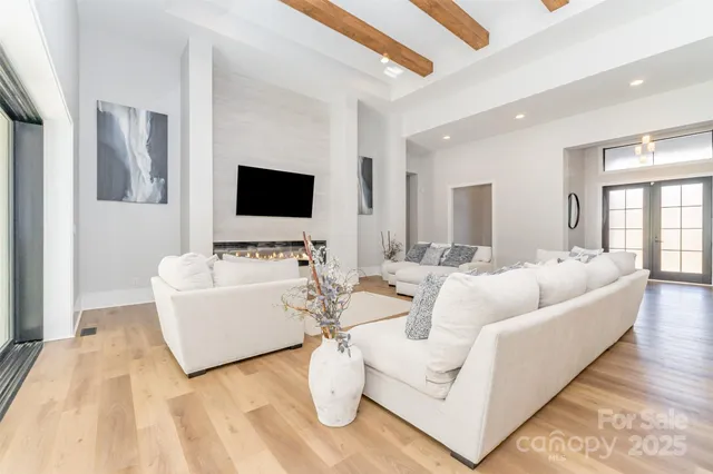 a living room with couches and a flat screen tv