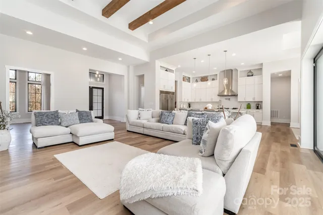 a living room with furniture white walls and wooden floor