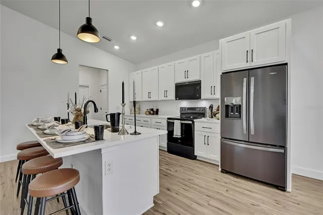 a kitchen with a sink stove and cabinets