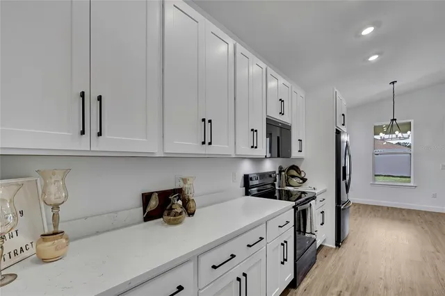 a view of empty room with wooden floor and window