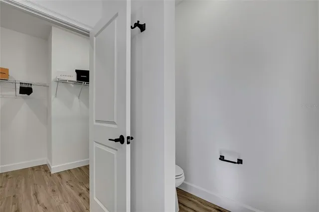 a bathroom with double vanity sinks a toilet a mirror and shower