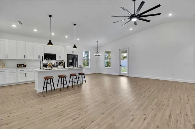 a view of kitchen with table and chairs