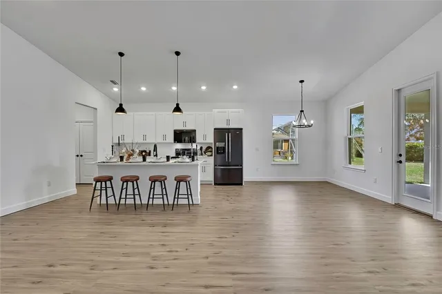 a view of an empty room with a kitchen