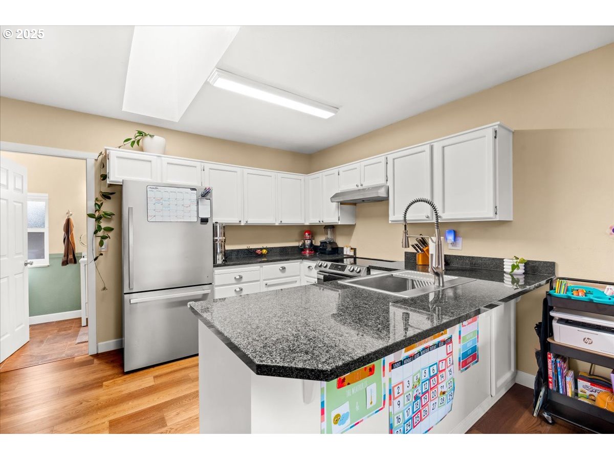 1720 B Street Forest Grove, OR 97116 - Photo 15 of 38 a kitchen with stainless steel appliances granite countertop a sink refrigerator and cabinets