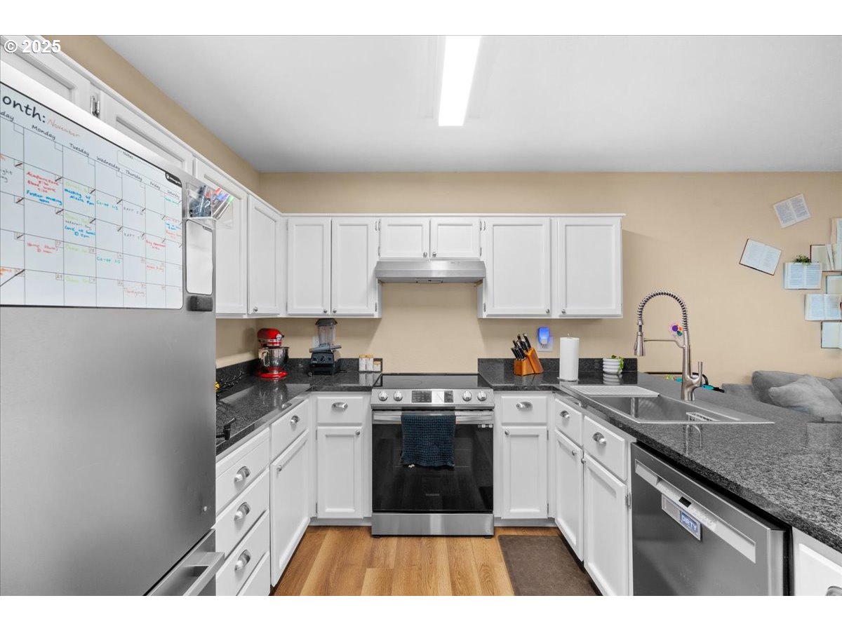 1720 B Street Forest Grove, OR 97116 - Photo 16 of 38 a kitchen with granite countertop a stove top oven sink and cabinets