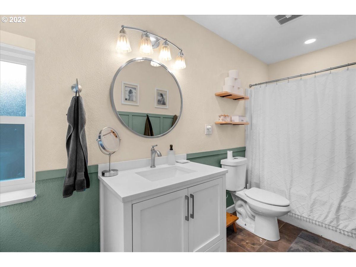 1720 B Street Forest Grove, OR 97116 - Photo 24 of 38 a bathroom with a sink a toilet and a mirror