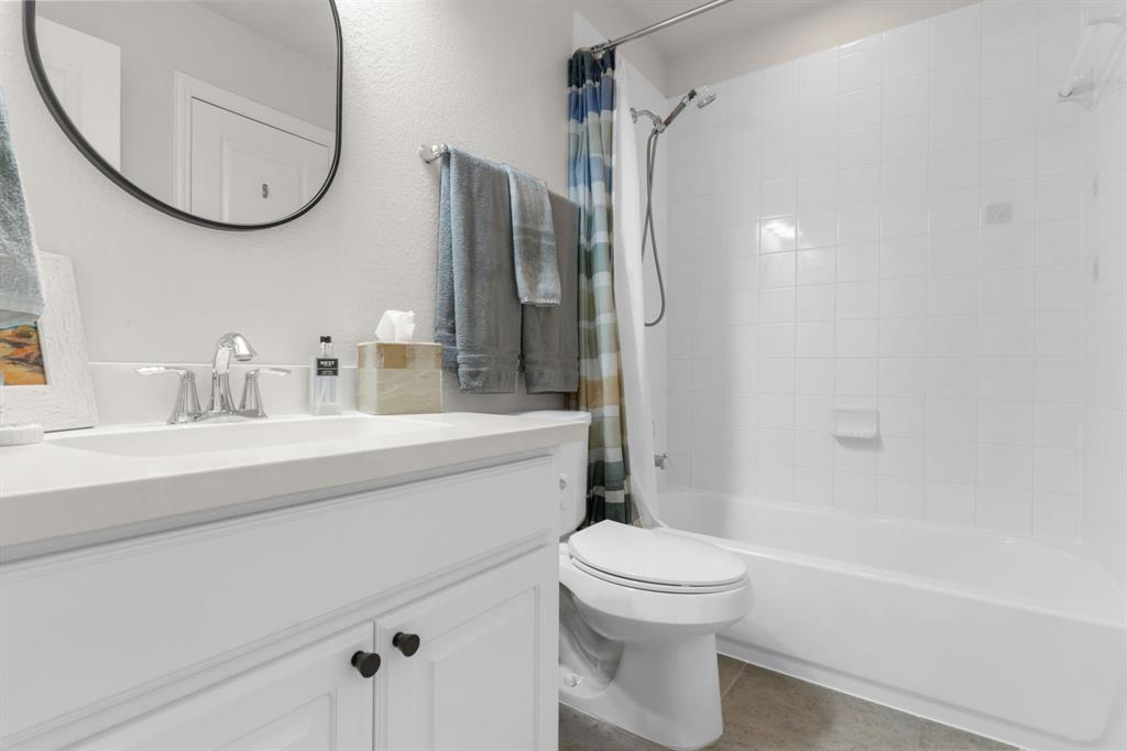 853 Field Crossing Little Elm, TX 76227 - Photo 19 of 24 a bathroom with a sink a toilet and a mirror