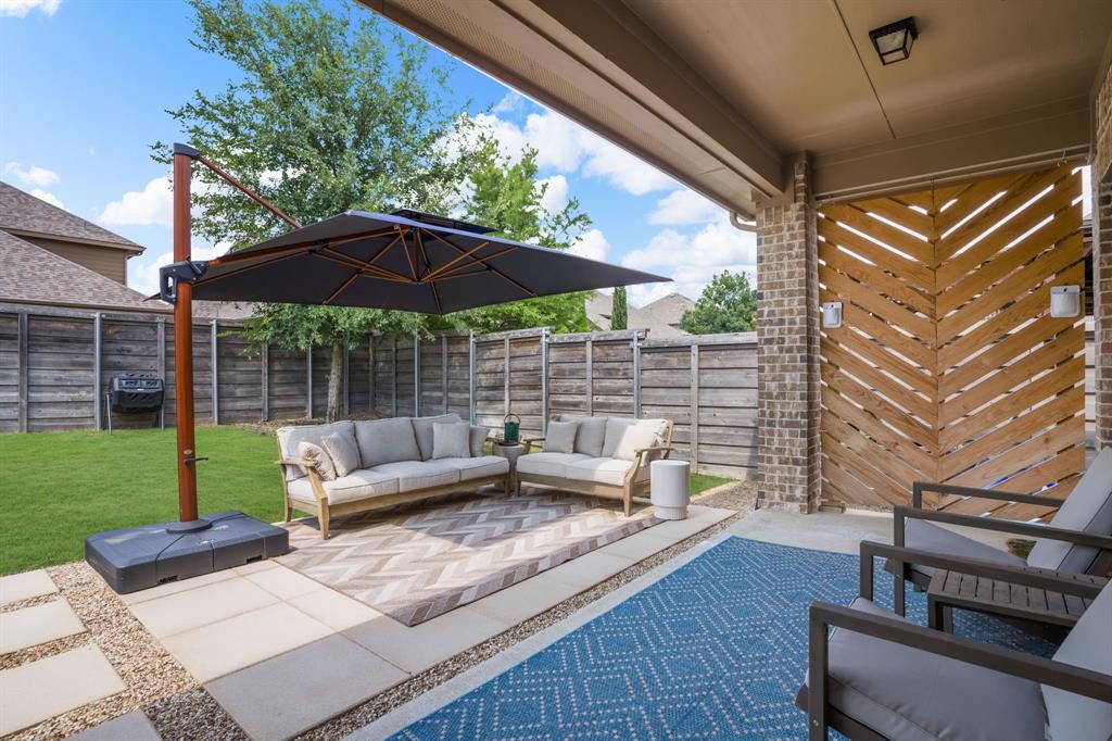 853 Field Crossing Little Elm, TX 76227 - Photo 23 of 24 a view of a patio with couches chairs under an umbrella
