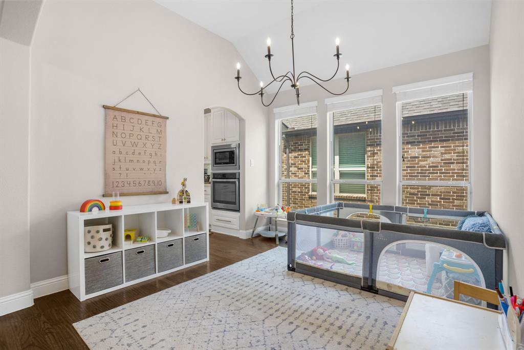 853 Field Crossing Little Elm, TX 76227 - Photo 6 of 24 a living room with furniture and a chandelier