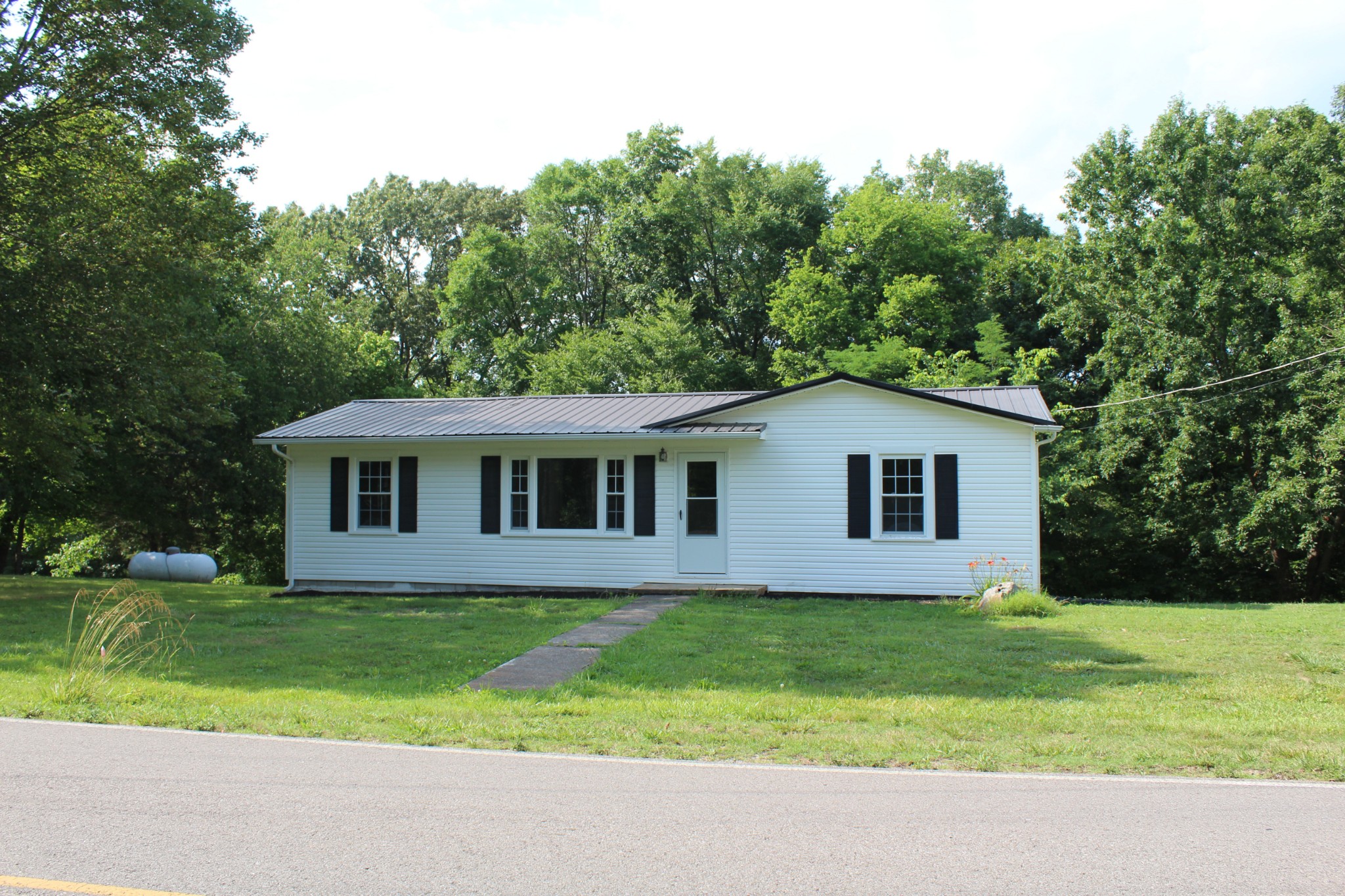 a front view of house with yard and green space
