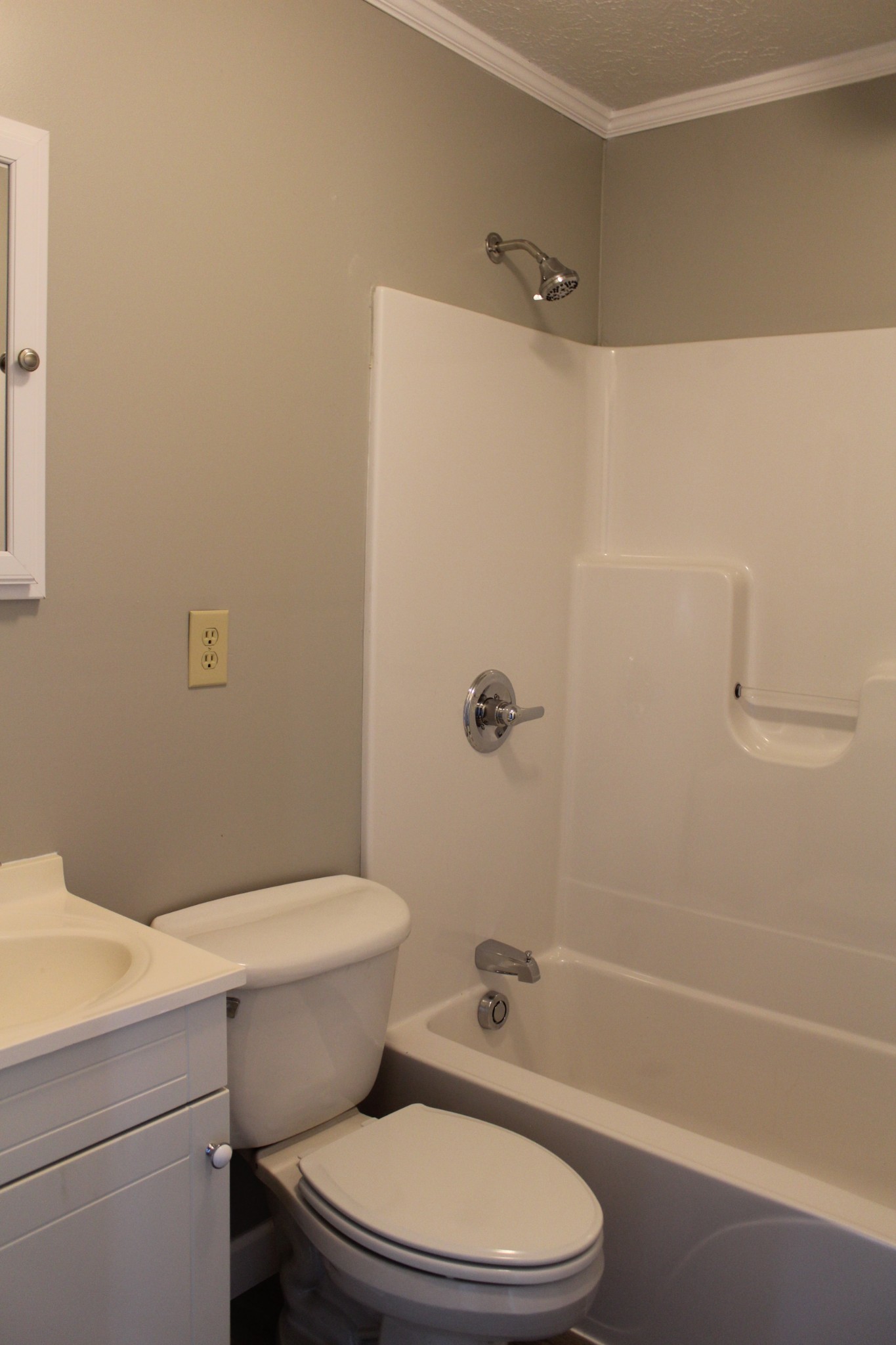 1275 Herman Adams Road Cumberland City, TN 37050 - Photo 14 of 25 a white toilet and tub sitting next to a bathroom sink