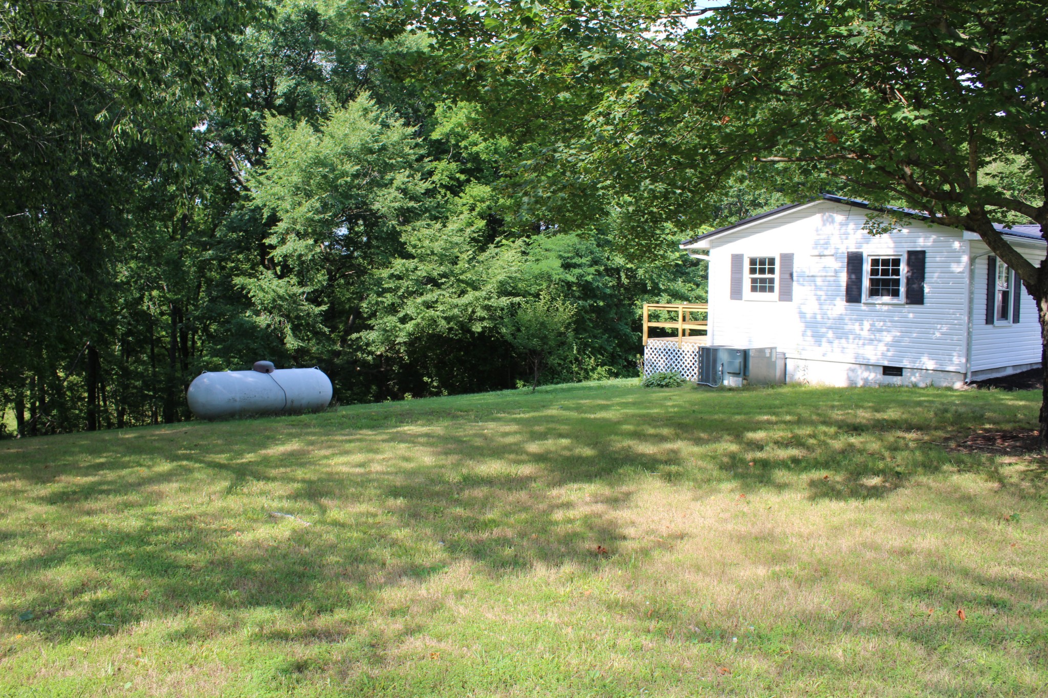 1275 Herman Adams Road Cumberland City, TN 37050 - Photo 16 of 25 a front view of a house with garden
