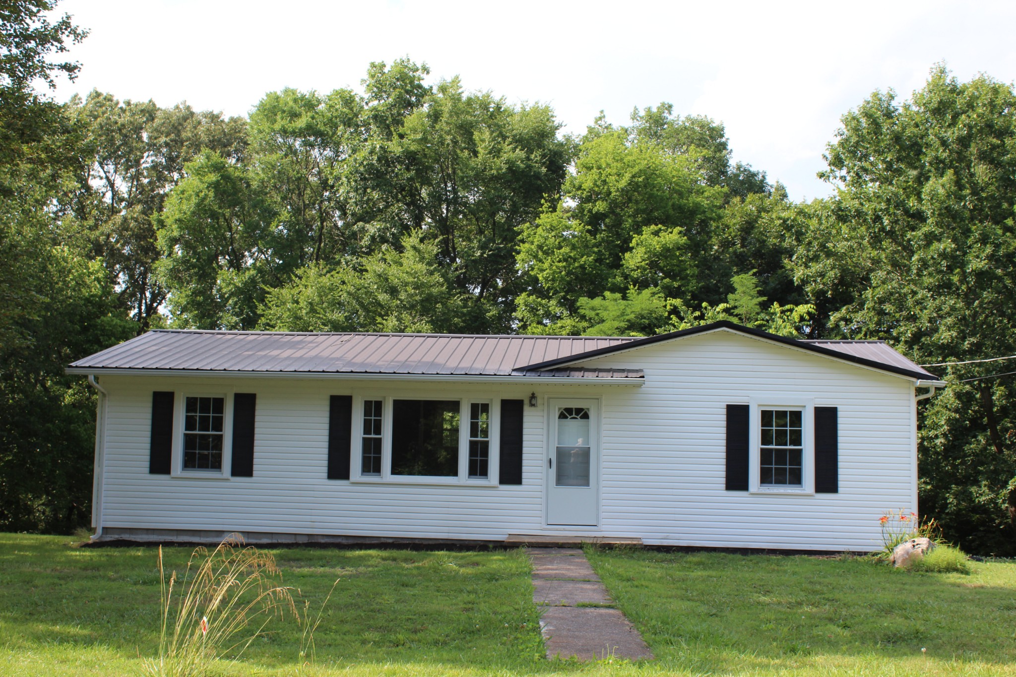 1275 Herman Adams Road Cumberland City, TN 37050 - Photo 20 of 25 a view of front a house with a yard
