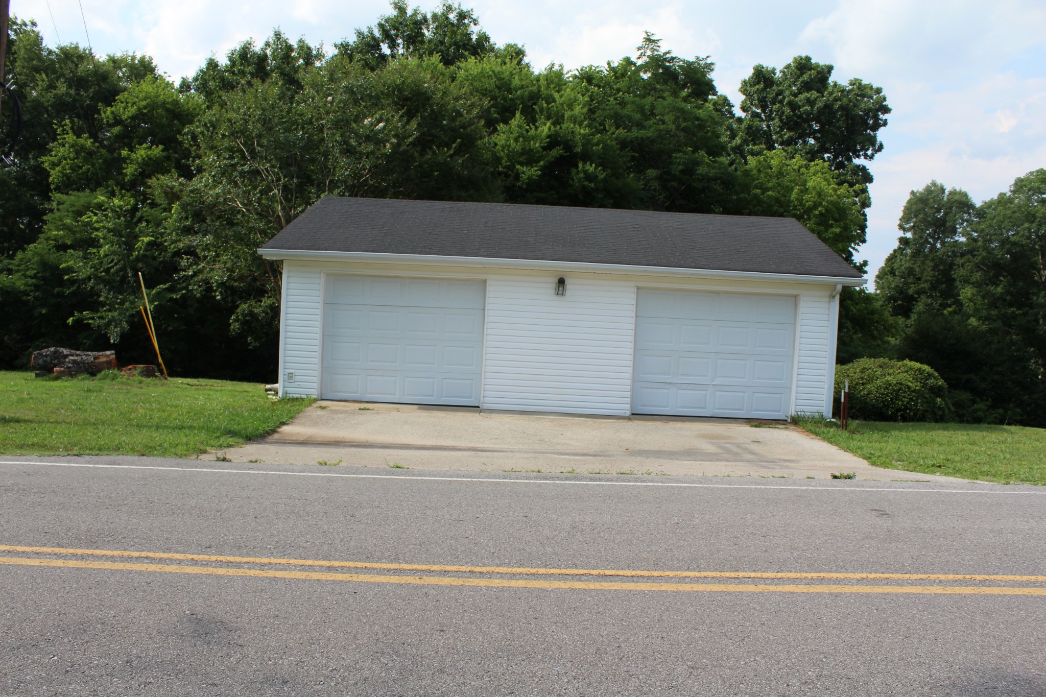 1275 Herman Adams Road Cumberland City, TN 37050 - Photo 25 of 25 a front view of a house with a yard and garage
