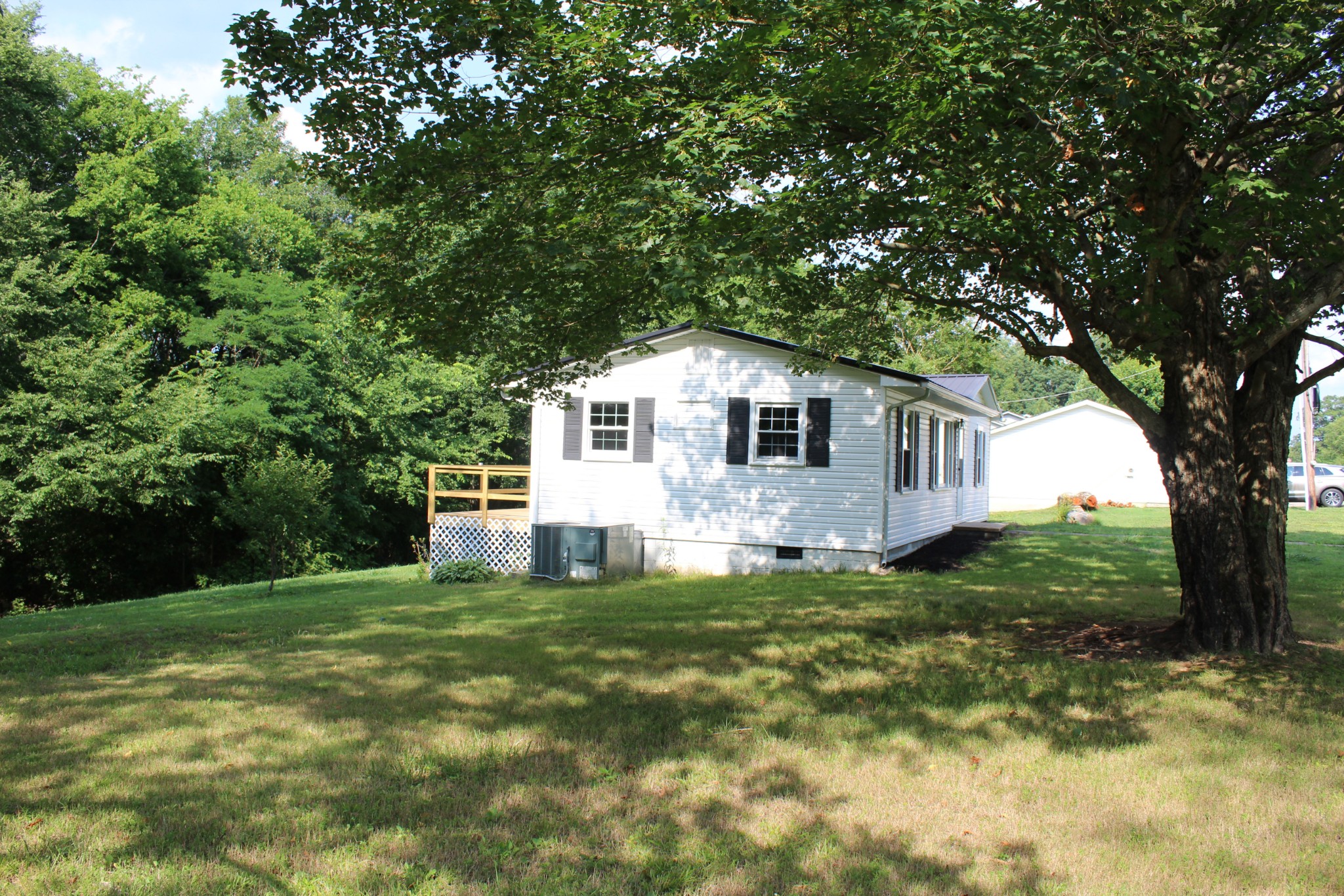 1275 Herman Adams Road Cumberland City, TN 37050 - Photo 4 of 25 a backyard of a house with table and chairs