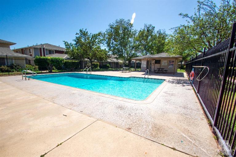 581 Spring Road, Unit 60 Moorpark, CA 93021 - Photo 3 of 7 a view of backyard with swimming pool and outdoor seating